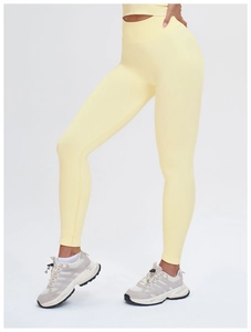 Macro detail of the lemon yellow seamless ribbed high waistband for tummy control