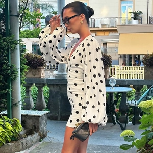Abito corto a pois con scollo a V e maniche a sbuffo su una terrazza di un caffè