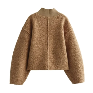 Detail showing brown sherpa fleece fabric texture on a long sleeve stand collar sweater