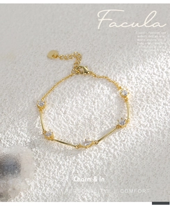 Close-up of gold-plated brass bracelet with marquee and round cubic zirconia stones