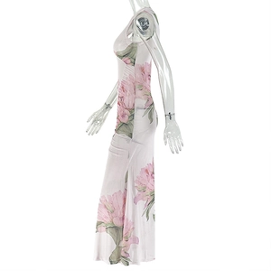 Detail of elegant sleeveless long dress featuring pink floral prints on light fabric