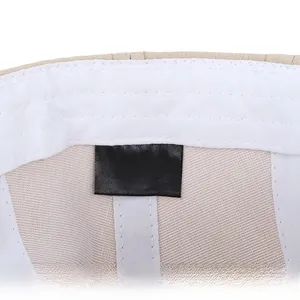 Detail view of the 100% cotton inner lining and stitching of the beige newsboy cap