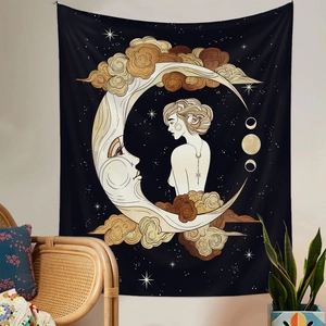 Detail of bohemian wall tapestry featuring a moon face, stars, and clouds in black and gold