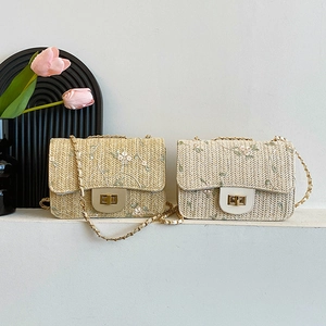 Straw woven crossbody bag with floral embroidery and gold chain strap in beige and natural