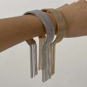 Detailed close-up of stylish stainless steel tassel bead bracelets in gold and silver