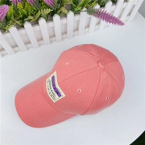 Pink cotton baseball cap with vintage boarding pass patch and breathable design