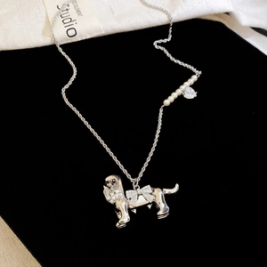 Detailed close-up of a silver puppy pendant necklace with zircon bow and pearl chain