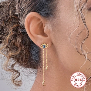 Elegant gold S925 sterling silver earrings with devil eye, star, and moon tassels