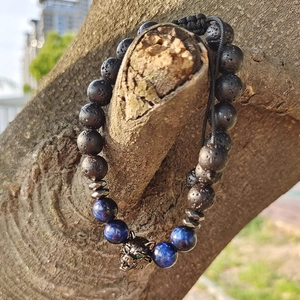 Adjustable tiger eye and obsidian beaded bracelet with a silver wolf head charm on a branch