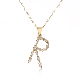 Macro shot of 18K gold plated necklace featuring letter R pendant with cubic zirconia