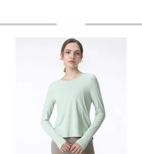 Close-up of mint green yoga top featuring slim fit design and thumbhole cuffs detail