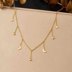 Detail of gold-plated stainless steel necklace with star, moon, and zircon pendants