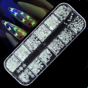 Detailed 12-grid box of glow-in-the-dark nail art sequins with star and heart shapes