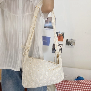 Detail of floral canvas bag with daisy print and adjustable ribbon shoulder straps