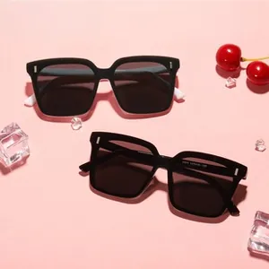 Detail of square oversized sunglasses with black and white frames on a summer prop display