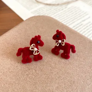 Retro red velvet pony earrings with golden bow and pearl detail for women