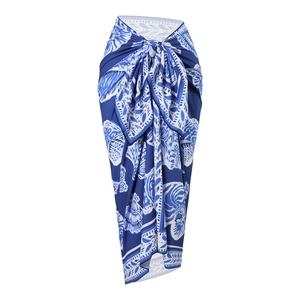 Detail of blue and white ethnic print beach wrap skirt with a tie waist knot