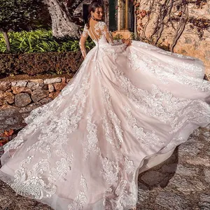 Exquisite back detail of ivory lace wedding dress with long train and pearl buttons
