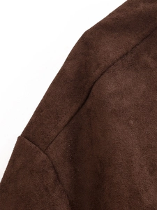 Macro shot of dark brown faux suede fabric showing detailed stitching and soft texture