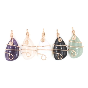 Five assorted wire-wrapped crystal teardrop pendants in various natural stone colors