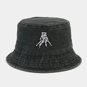 Close-up of distressed denim bucket hat with hand embroidery and stitched brim detail