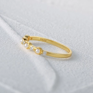 Macro shot of S925 sterling silver stamp on vintage pearl and zircon gold plated ring