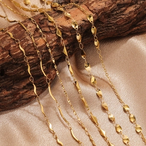 18K gold plated stainless steel necklaces with S-chain and stick links on wood bark