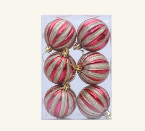Detail of six red and gold spiral Christmas ornaments in a transparent box