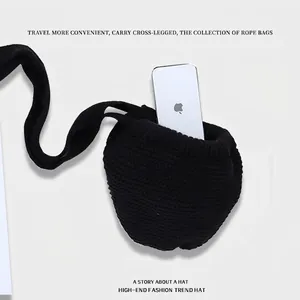 Minimalist black knitted crossbody mini phone bag with soft handmade woven texture