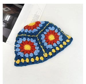 Detailed view of colorful handmade crochet floral patterns on a vintage knit bucket hat