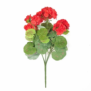 Detailed view of realistic artificial red geranium bouquet with textured green leaves