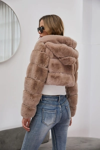 Detail view of the plush texture and back cut of this pink faux fur hooded jacket