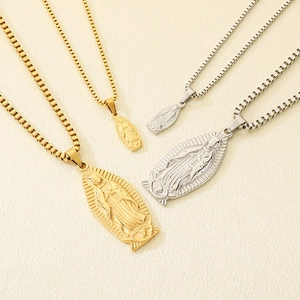 Detailed view of Our Lady of Guadalupe necklaces in gold and silver finish on box chains