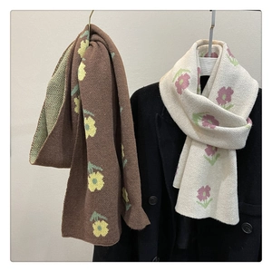 Detailed close-up showing thick floral knitted scarves in brown and cream textures