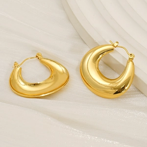 Elegant gold-plated thick C-shaped hoop earrings on white silk background with high polish