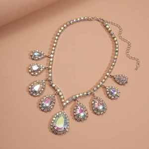 Macro shot of silver-colored teardrop crystal pendant necklace with sparkling AB rhinestones