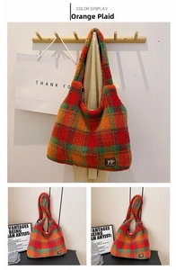Detailed close-up of orange plaid plush tote bag texture with wide shoulder strap