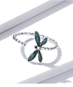Detailed macro view of an enamel dragonfly ring with green wings and pavé zircon stones