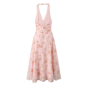 Detail view of pink floral halter neck dress with deep V backless design on white background