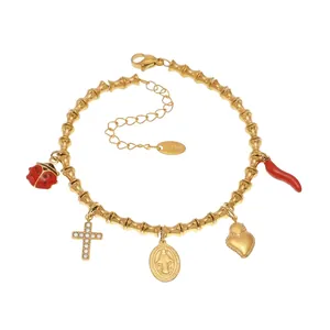Detail view of 18k gold plated bracelet with ladybug heart and cross charms