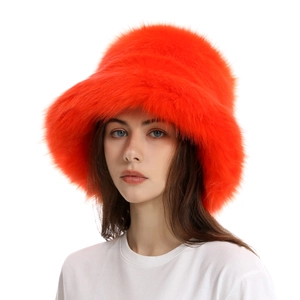 Detailed texture of thick orange faux fur on a women's plush winter bucket hat
