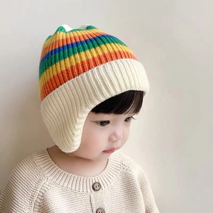 Detail of baby knitted earflap hat featuring colorful stripes and cute cat ear design