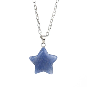 Close-up of pentagram pendant made of natural blue crystal with silver metal chain