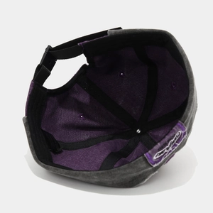 Detail view of washed denim docker hat showing purple lining and adjustable buckle strap