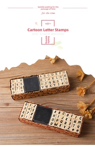 Macro detail of 40-piece vintage typewriter wooden letter and number stamps set with ink