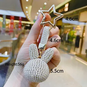 Detailed view of rhinestone rabbit keychain with pearl texture and gold star clasp