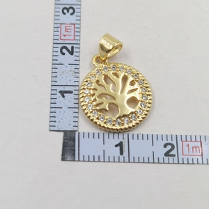 Detailed close-up of a 2cm gold Tree of Life pendant with micro-inlaid cubic zirconia