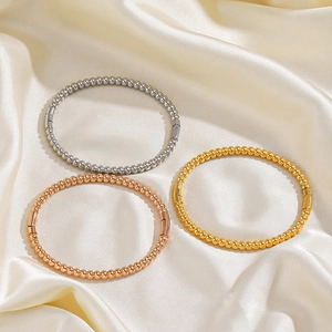 Set of three stainless steel beaded bangles in gold silver and rose gold on silk