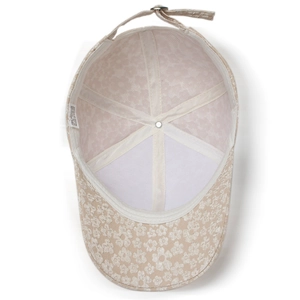 Inside view of beige women's baseball cap with lace embroidery and six-panel stitching