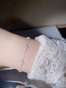 Macro shot of S925 sterling silver four-leaf clover bracelet with zircon on wrist